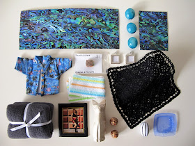 One-twelfth scale miniature paua splashbacks, vases, Hawaiian shirt, frames and crocheted rug.