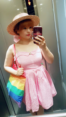 auris wearing a pink swankiss dress and a straw hat