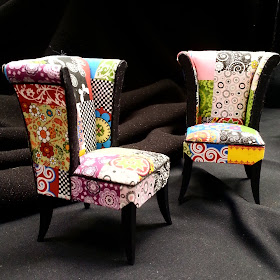 Two one-twelfth scale miniature modern armchairs, covered in a patchwork of bright fabrics.