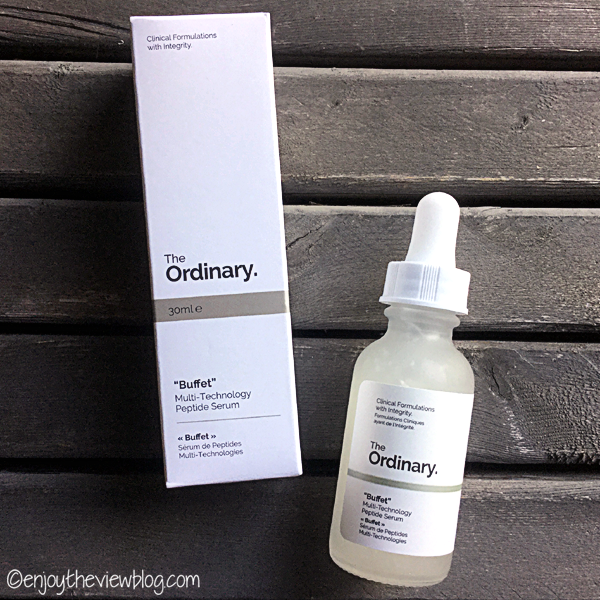 The Ordinary "Buffet" Peptide Serum product bottle and box lying on a wooden surface