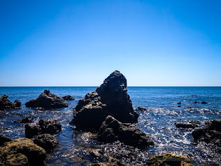 Natural Tropical Beach View With Chunk Of Rocks In The Clear Blue Sky On A Sunny Day At Umeanyar Village North Bali Indonesia