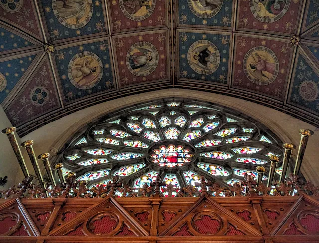 Stained glass rose window and organ pipes inside the church at St. Patrick's College in Maynooth, Ireland