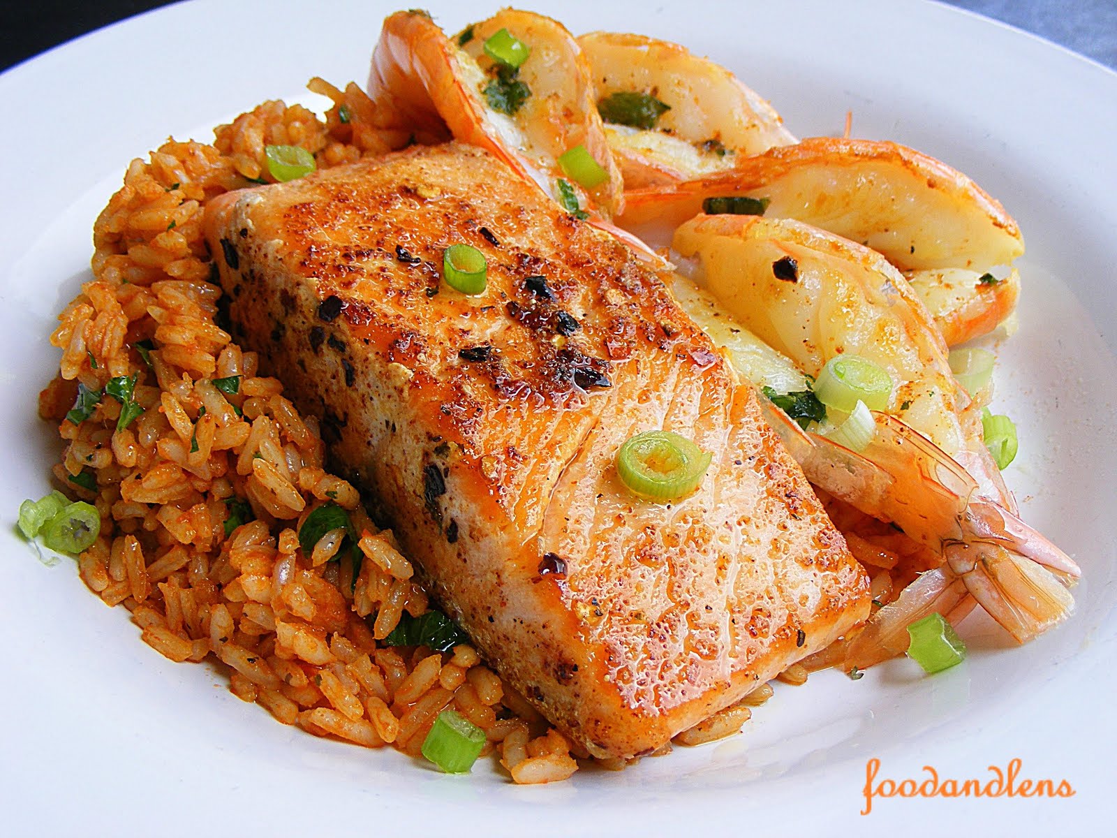 Food and lens Jollof Rice With Grilled Salmon And Shrimp.