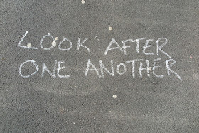Chalk hand-lettering, reads "LOOK AFTER ONE ANOTHER"