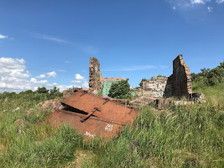 A set of large heavy doors covered in rust lie next to a small, demolished building on Cramond Island, Edinburgh.  Photo by Kevin Nosferatu for the Skulferatu Project.
