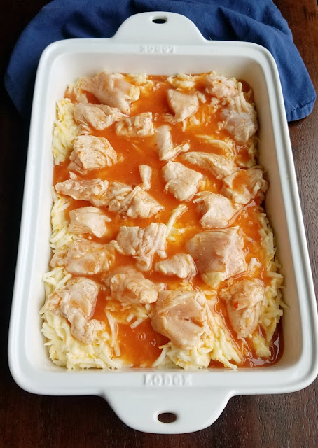 buffalo chicken and potatoes in dish ready to bake