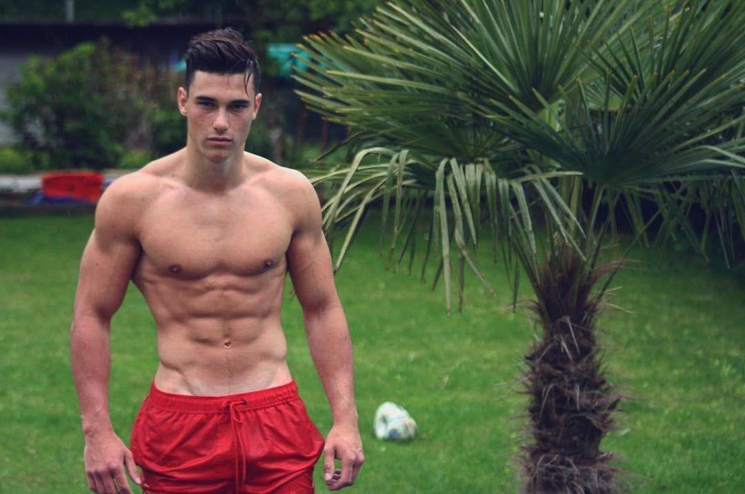 shirtless-fit-guy-alexandre-tete-green-grass-lawn-palm-tree