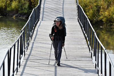Hiker on Trans Canada Trail floating boardwalk near Winnipeg.