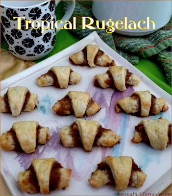 Tropical Rugelach is cream cheese based dough, topped with a sweet filling and rolled up crescent style. Featuring orange, pineapple and ginger this cookie makes you long for summer. | Recipe developed by www.BakingInATornado.com | #recipe #bake