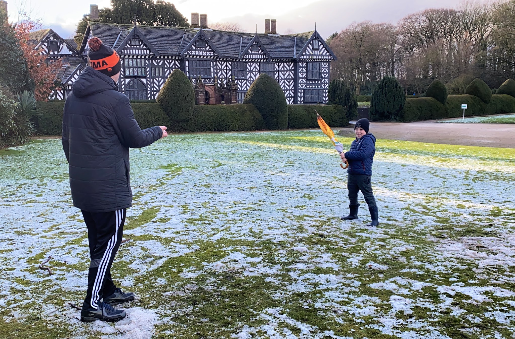 man and boy having a snowball fight