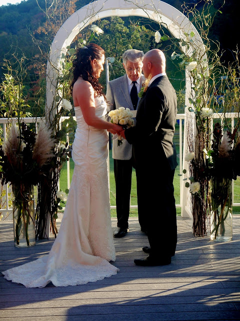 bride and groom under arch