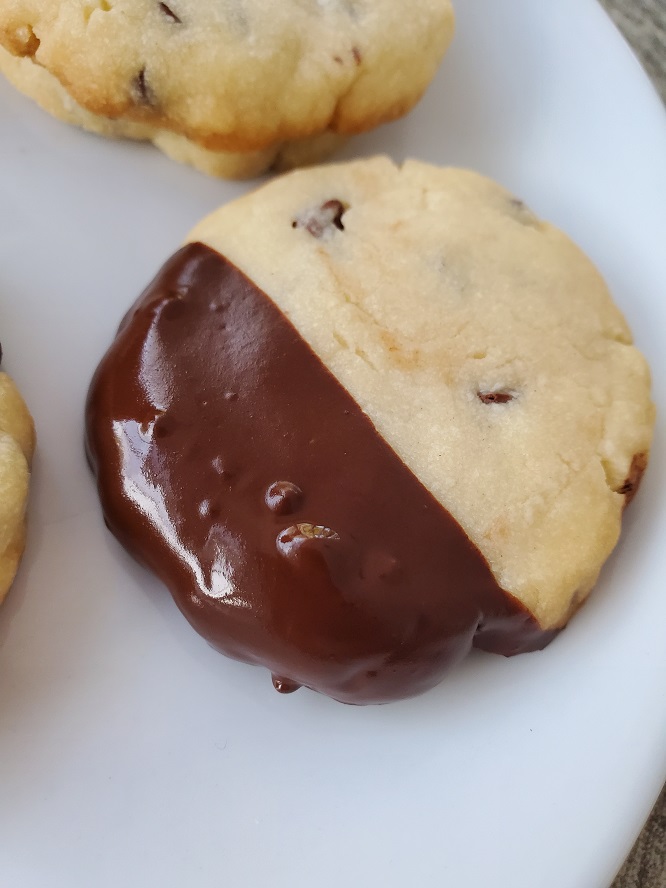 this is a chocolate chip shortbread cookie dipped into chocolate ganache on one end