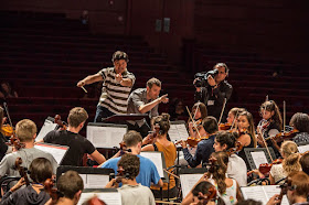 Bruno Campo & Etienne Abelin rehearsing the Sistema Europe Youth Orchestra in Milan 2015 © Marco Caselli Nirmal