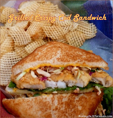 Grilled Crispy Cod Sandwich: Crispy Cod Fingers and Smoky Slaw between a smothered grilled cheese sandwich. | Recipe developed by www.BakingInATornado.com | #recipe #sandwich