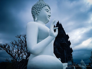Dark Cloudy Sky On Big White Buddha Statue In The Garden At Buddhist Monastery In Bali Indonesia