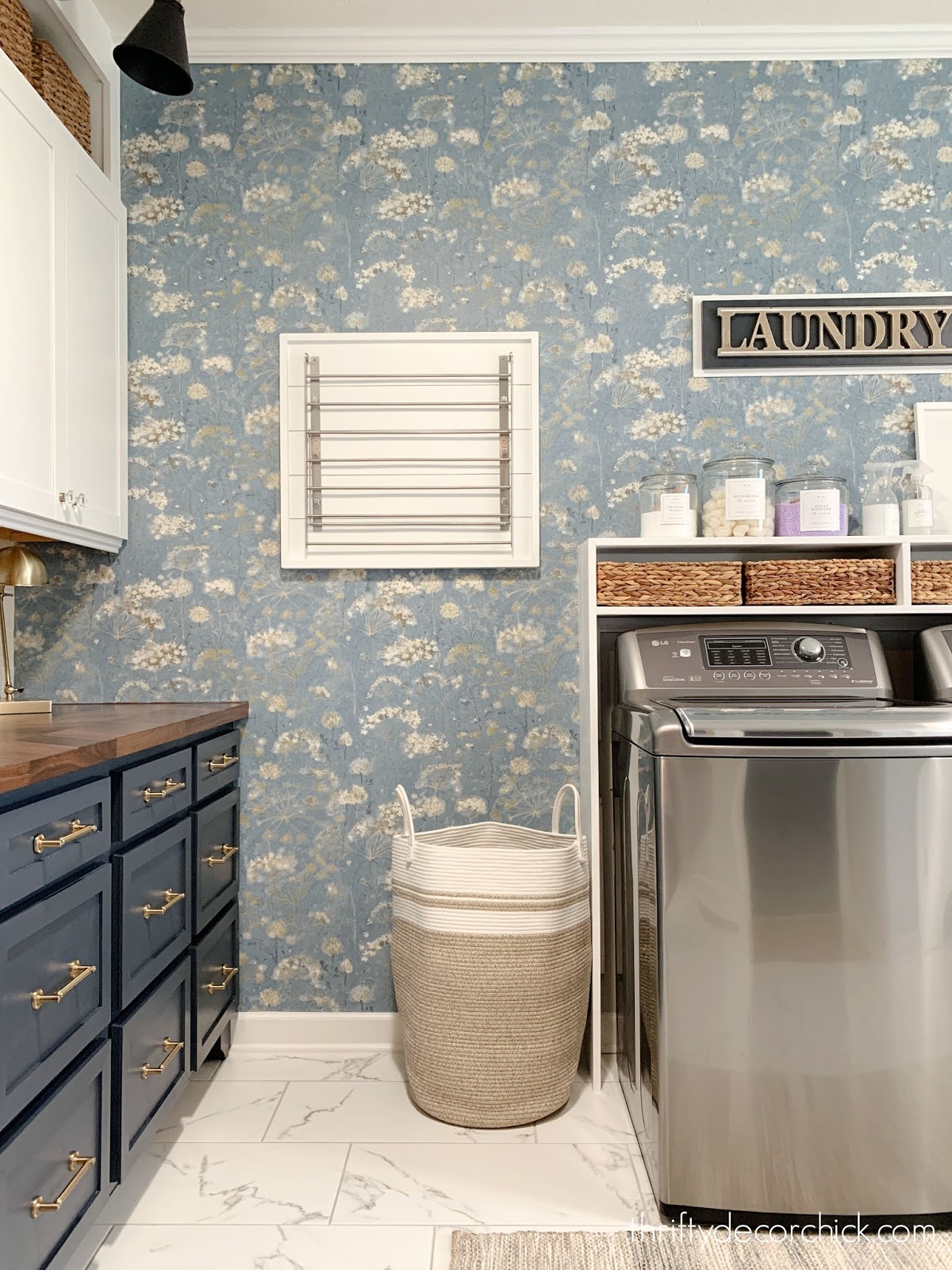 laundry room with floral wallpaper