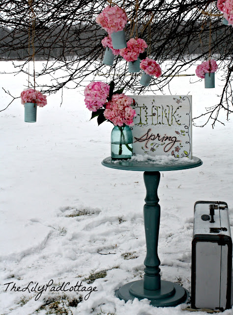 A sign on the side of a snow covered street