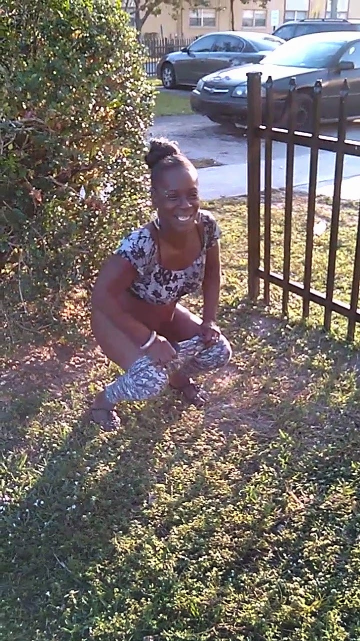 YTPeeClip0541: Black girl is peeing on the grass.