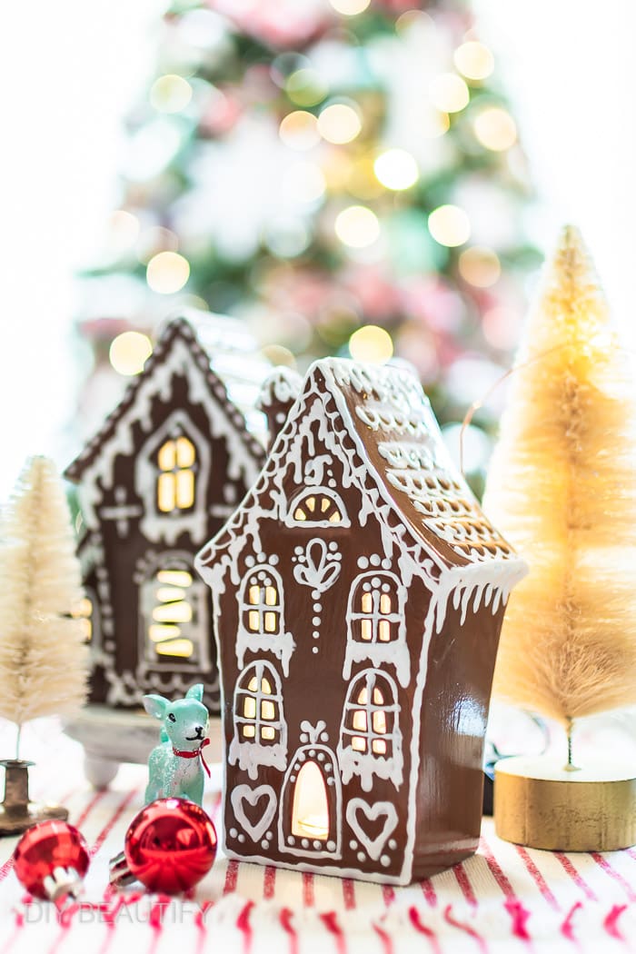 high gloss gingerbread house with ornaments, deer figurine and bottle brush trees