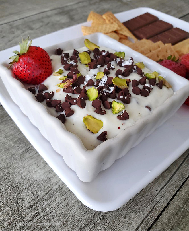 this is how to make easy cannoli dip with ricotta cheese that has chocolate chips and pistachios on top