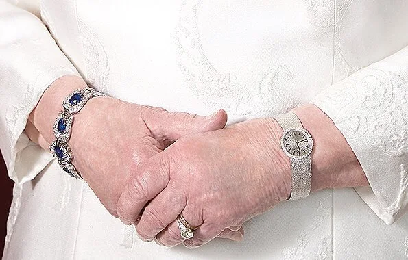 Queen Elizabeth is wearing Sovereign of the Order of Canada and the Order of Military Merit and Modern Sapphire Tiara and George VI Sapphire parure