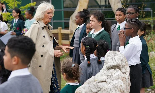 The Duchess of Cornwall wore a navy blue, feather-print dress from Fiona Clare