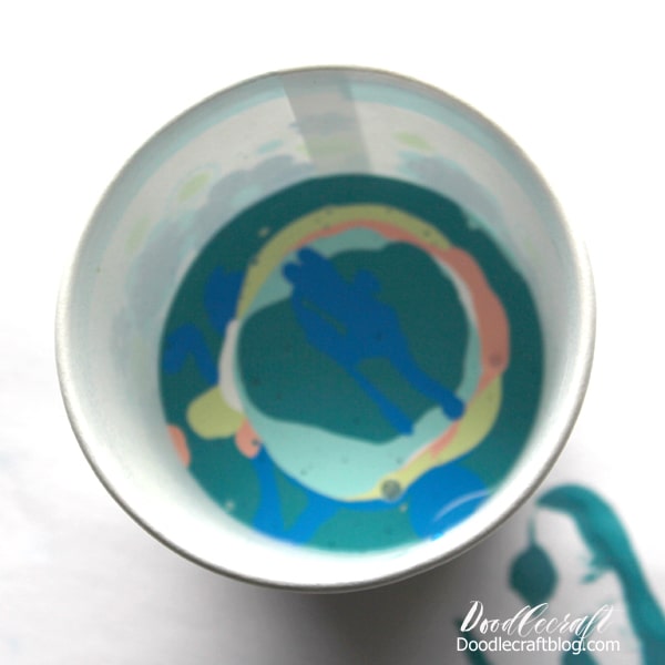 Step 2 Acrylic Pouring: Start with an empty paper cup. Then pour out the acrylic paint into the cup in a "bullseye" pattern. It does not have to be precise. Just add some of this and some of that!