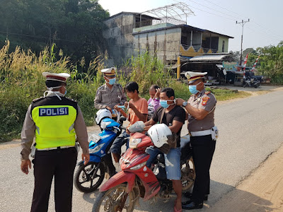 Antisipasi Debu dan Asap Karhutla, Satlantas Polres Melawi Bagikan Masker ke Pengendara