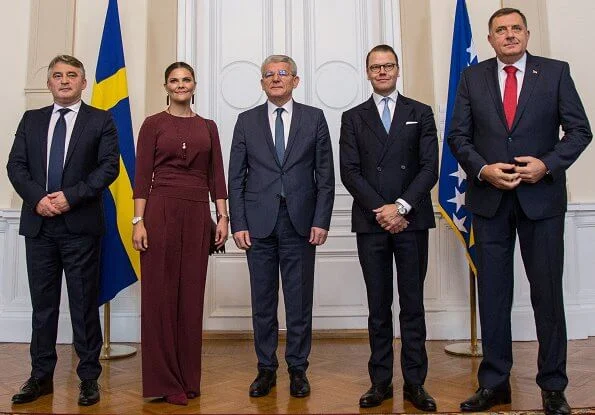 Crown Princess Victoria wore Andiata Kamille trousers and Kiana blouse. Vogt bag and Stinaa J boots. Oscar de la Renta earrings