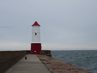 Berwick Lighthouse, a red and white lighthouse on the end of a pier in Berwick upon Tweed.  Photo by Kevin Nosferatu for the Skulferatu Project.
