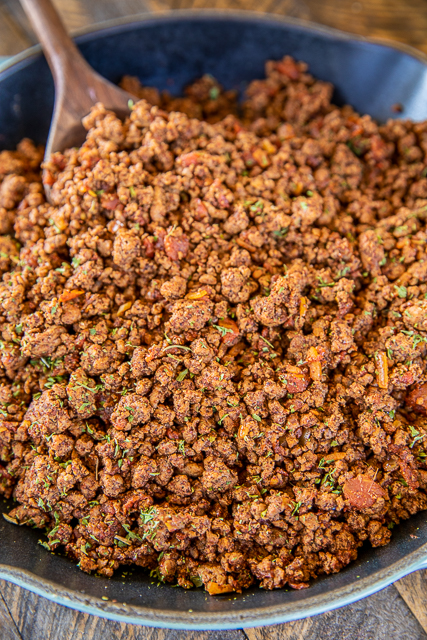 The BEST Taco Meat - our go-to recipe for taco night. Tastes as good as our favorite Mexican restaurant! Super easy to make and ready to eat in about 15 minutes. Ground beef, onion, garlic, chili powder, salt, cumin, diced tomatoes and green chiles, red pepper flakes, and water. You will never use a packet of taco seasoning again! Can freeze leftovers for a quick meal later. A must for taco night! #taco #groundbeef #mexican #tacomeat taco meat in a skillet