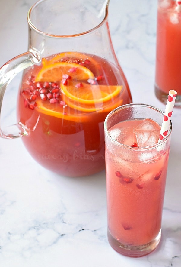 a glass and pitcher with christmas morning punch