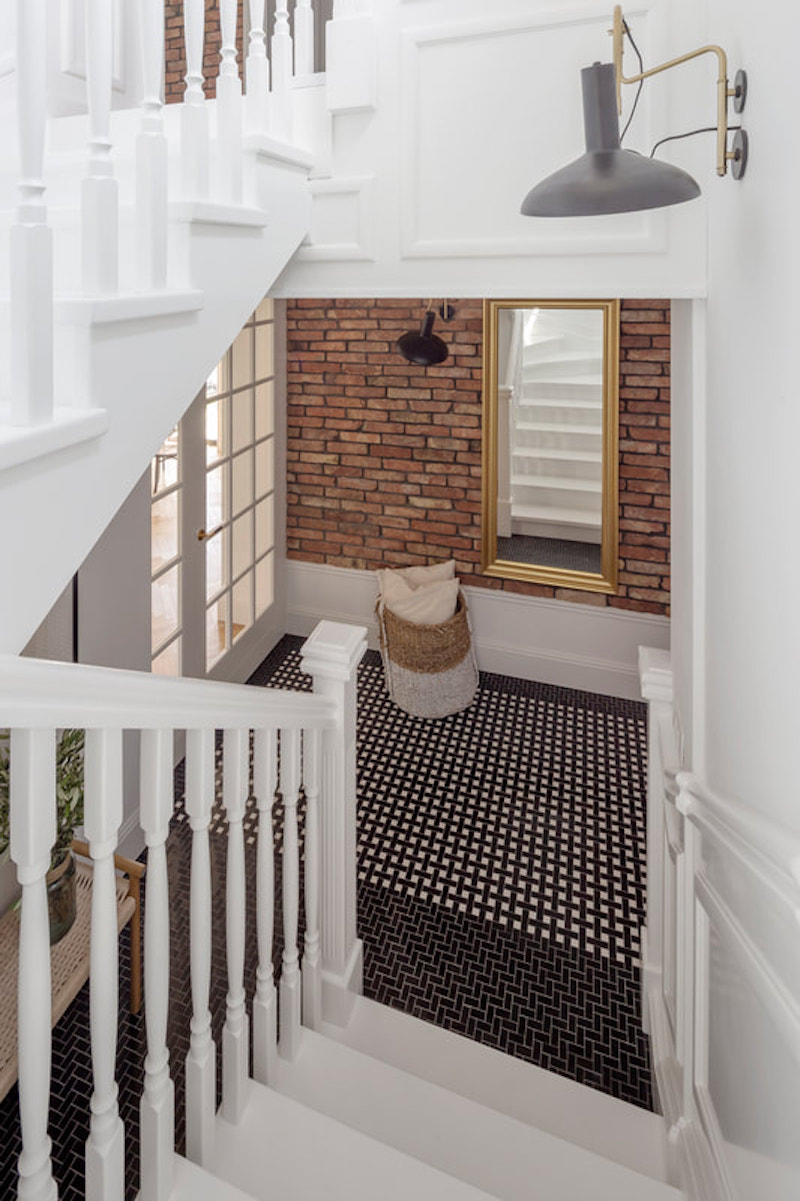 Cómo decorar con molduras y zócalos para sumar estilo a tu casa Escalera con barrotes de madera blanca y paredes con zócalos y molduras