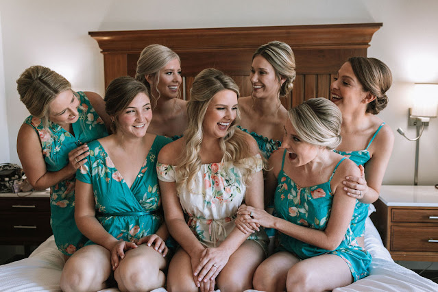bride with bridesmaids in getting ready rompers