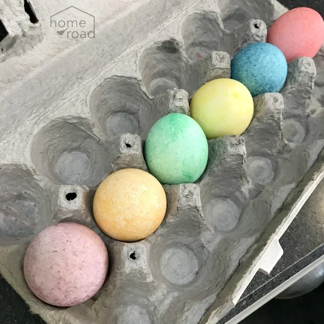 Carton of rainbow colored eggs