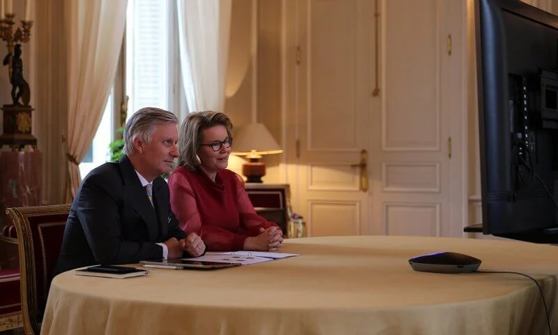 Marie du Chastel, Cleo Goyvaerts, Jamila Louahed and Hylke Vandenbussche. Queen Mathilde wore a red tulle long sleeve midi dress from Natan