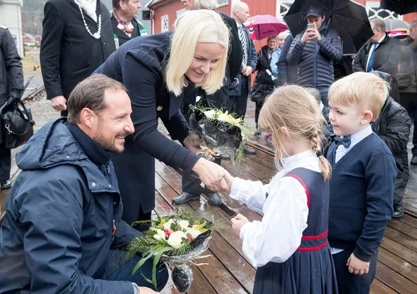 Crown Princess Mette-Marit wore Valentino coat and she wore Prada Brown Knee High Crocodile Boots. Telemark Rjukan-Notodden heritage site