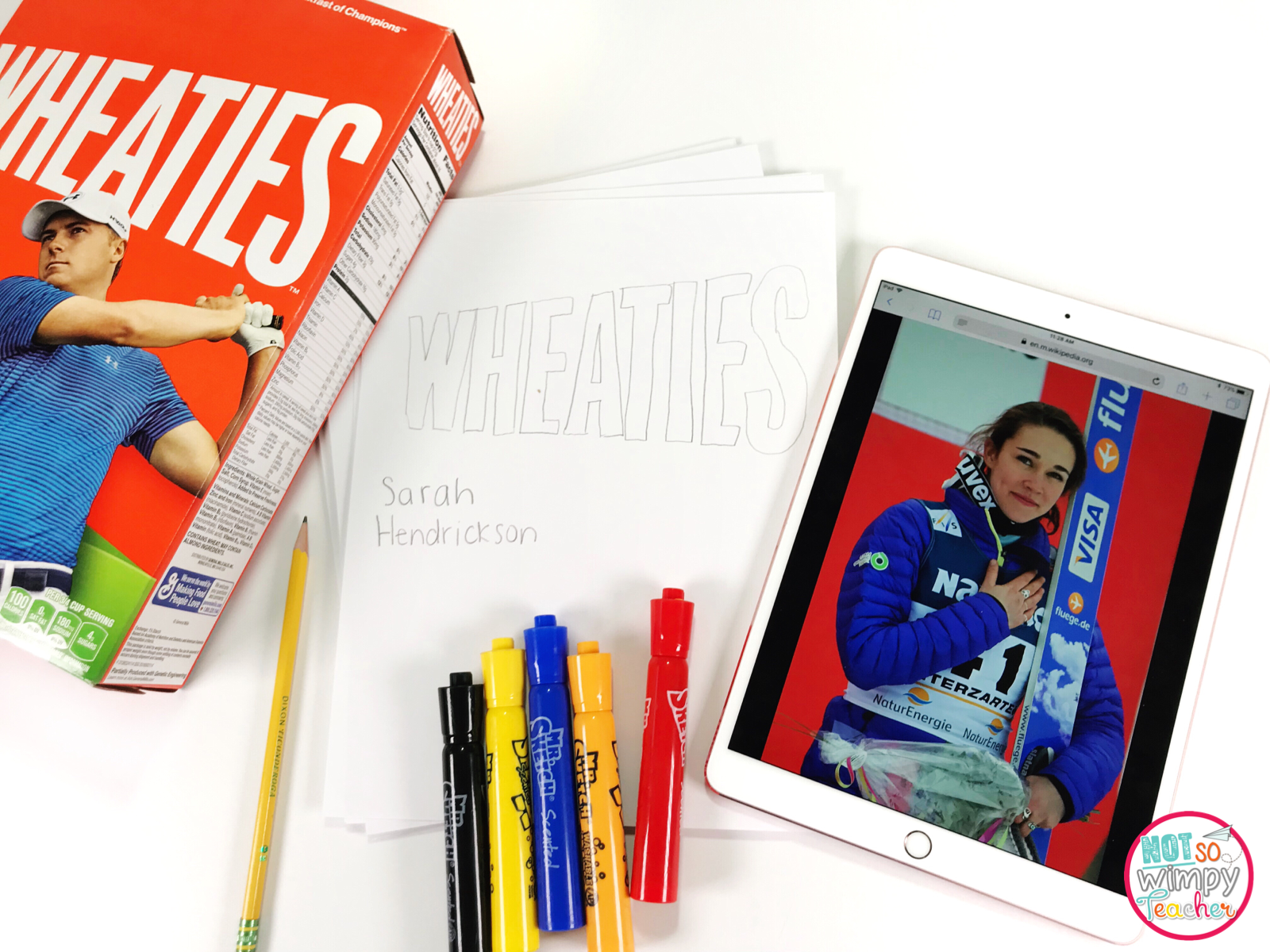 Wheaties box Olympics project with supplies for project including iPad for research, paper, pencil and Mr. Sketch markers