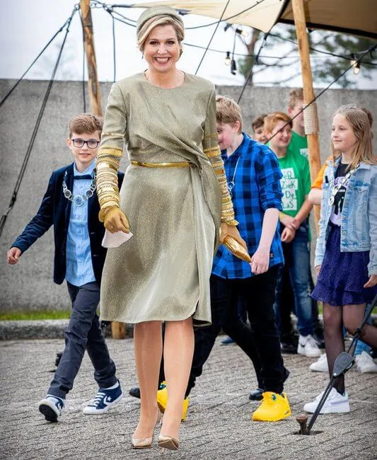 Queen Maxima wore an embellised draped midi dress by Claes Iversen. Gianvito Rossi gold plexi pumps. Begum Khan clutch bag