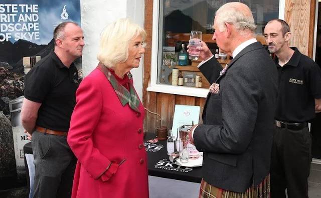 Duchess wore a waist-cinching red coat with a tartan lapel and tan heels. Camilla added a sapphire and diamond brooch