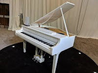 Polished white digital grand piano