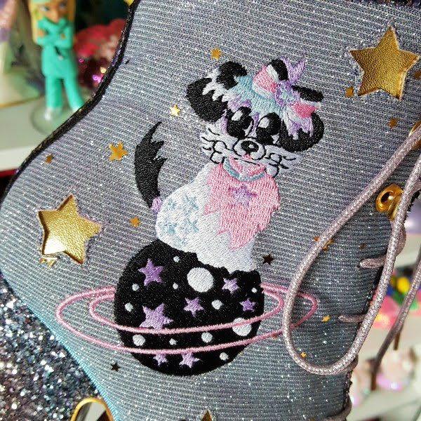 close up of dog on planet embroidery on side of ankle boot