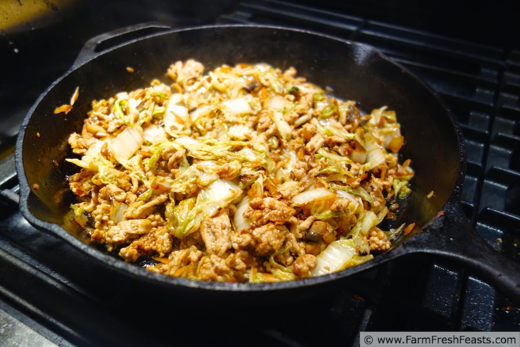 Ground chicken, Chinese cabbage, and mushrooms with hoisin sauce, rolled up Mu Shu style. This recipe can be served to vegetarians and omnivores alike because the meat is cooked separately from the vegetable filling.