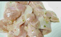 Marinating chicken pieces with spices for chicken malai tikka recipe