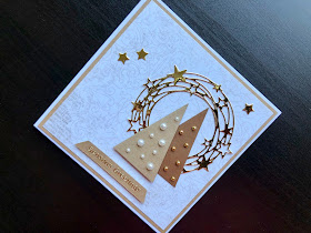 Hand made Christmas card with triangular Christmas trees and a gold star wreath