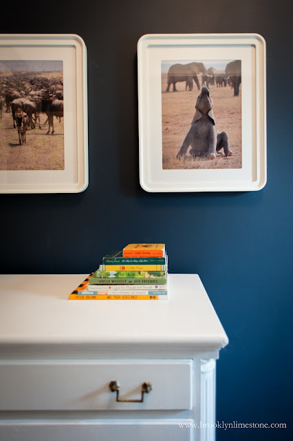 White dresser with books on top in safari nursery