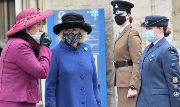 The Duchess of Cornwall wore a blue wool coat, and wears a face mask