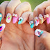 Whimsical vibrant nails with vivid feather accents