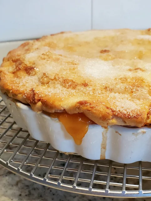 warm peach pie on cooling rack