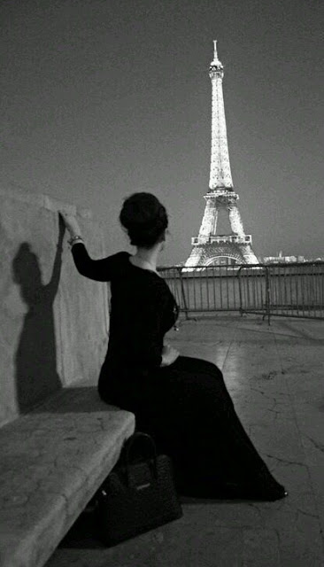 Woman and the Eiffel Tower at night